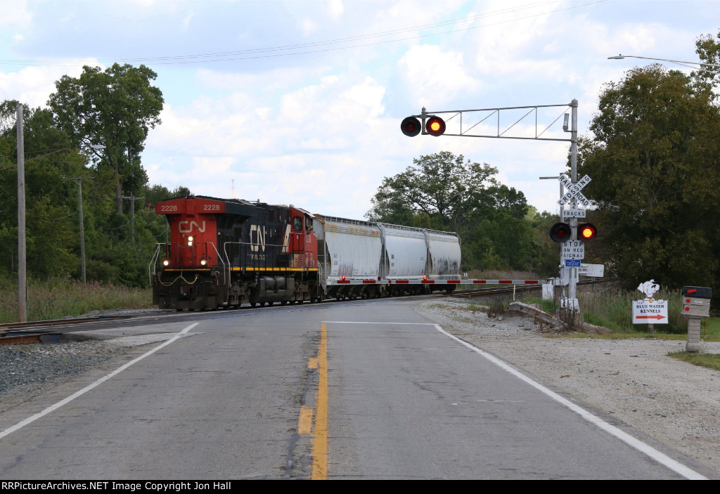Running long hood forward, 2228 leads three cars west for local industries